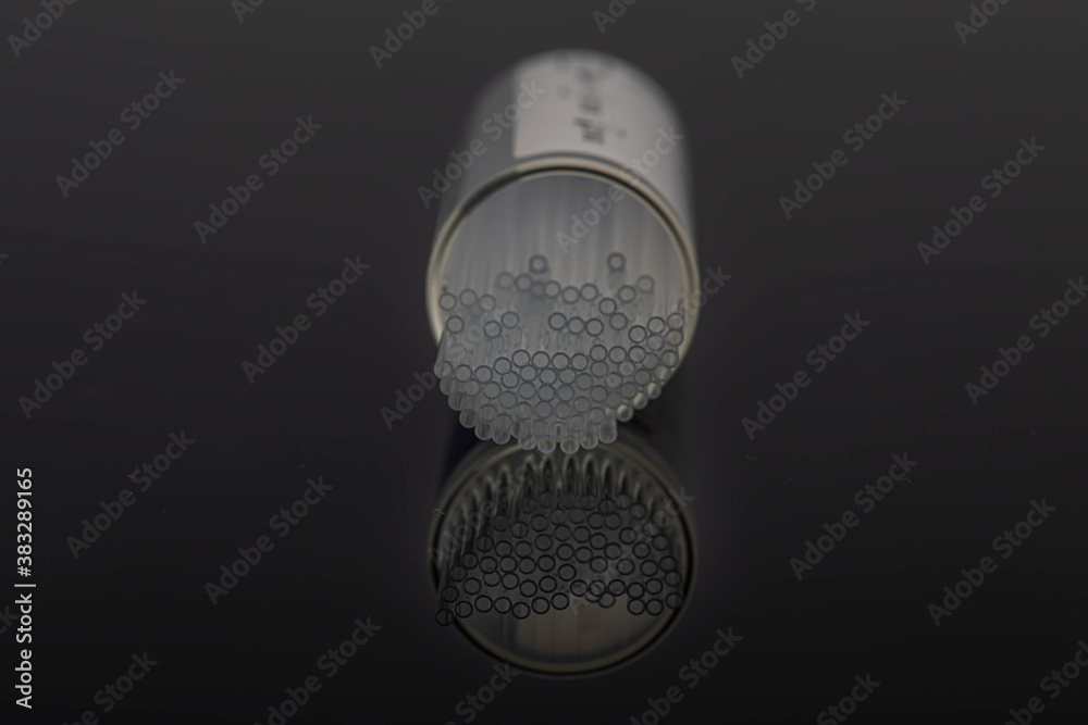 Hematocrit Capillary Tube. Medical capillary glass tubes on black background. Medical capillary