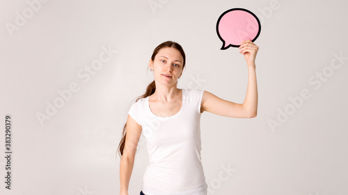 woman holding blank speech bubble on white background