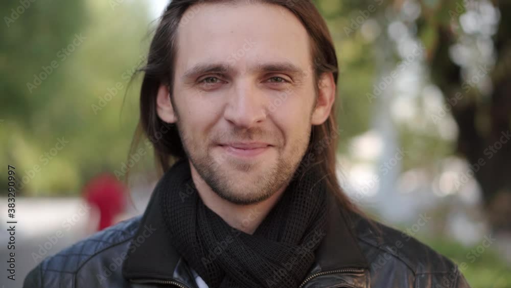 Portrait of attractive smiling cheerful male with beard looking to camera. Concept of people and emotions.