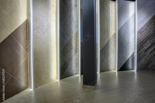 rows of ceramic tiles and natural stone inside of interior modern showroom shop photo