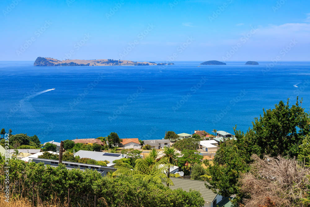 The Coromandel Peninsula, New Zealand, in summer.  A view of Slipper Island from the seaside holiday town of Tairua