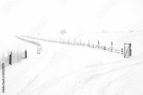 fence along snowy road