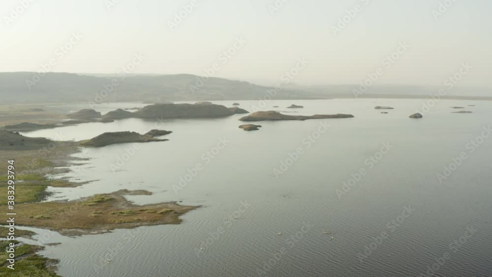 Drone video lake in the savannah with green trees and yellow earth on a background of beautiful landscape and mountains. Aerial shot Arusha Tanzania.
Drone video lake in the savannah with green trees and yellow earth on a background of beautiful landscape and mountains. Aerial shot Arusha Tanzania.