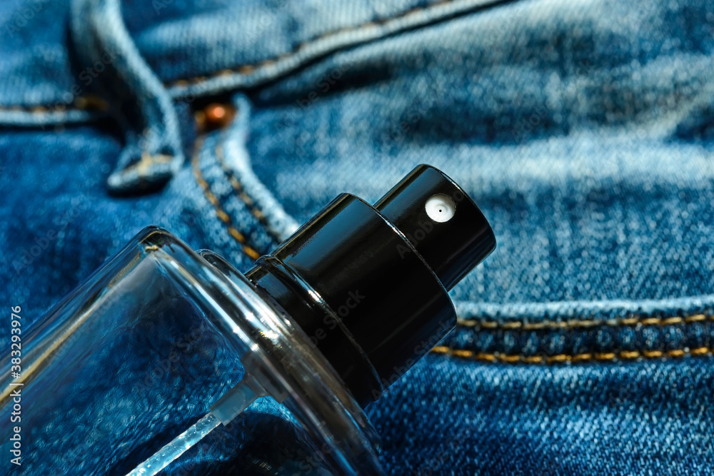 Glass bottle of unisex fragrant perfume or scented toilet water on a blue  denim. Casual light scent for everyone. Stock Photo | Adobe Stock