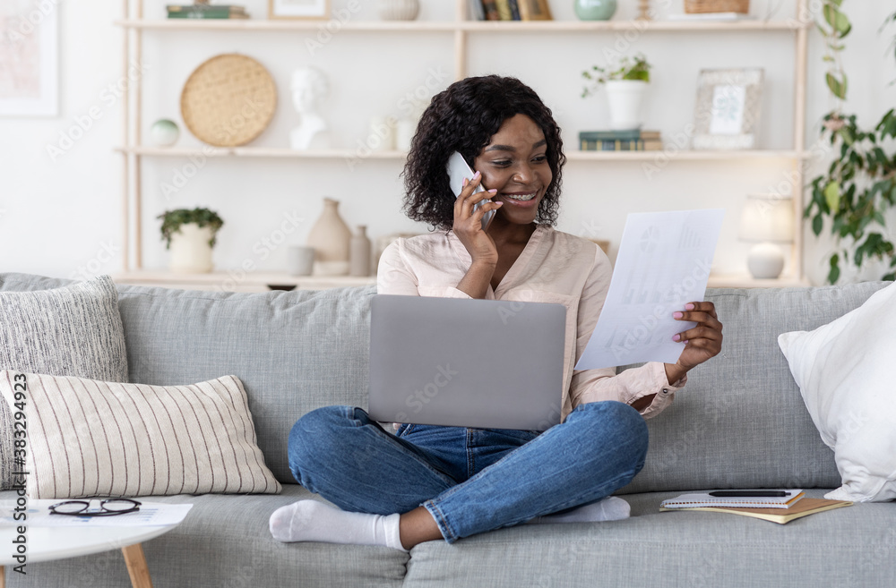 Woman Working With Documents And Laptop And Talking On Cellphone At Home Woman Working With Documents And Laptop And Talking On Cellphone At Home