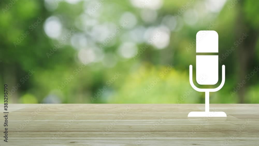 Microphone flat icon on wooden table over blur green tree in park, Business communication concept Microphone flat icon on wooden table over blur green tree in park, Business communication concept