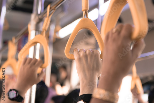 People hand holding handle on the bus gate. Donmuang, Bangkok, Thailand, Asia photo