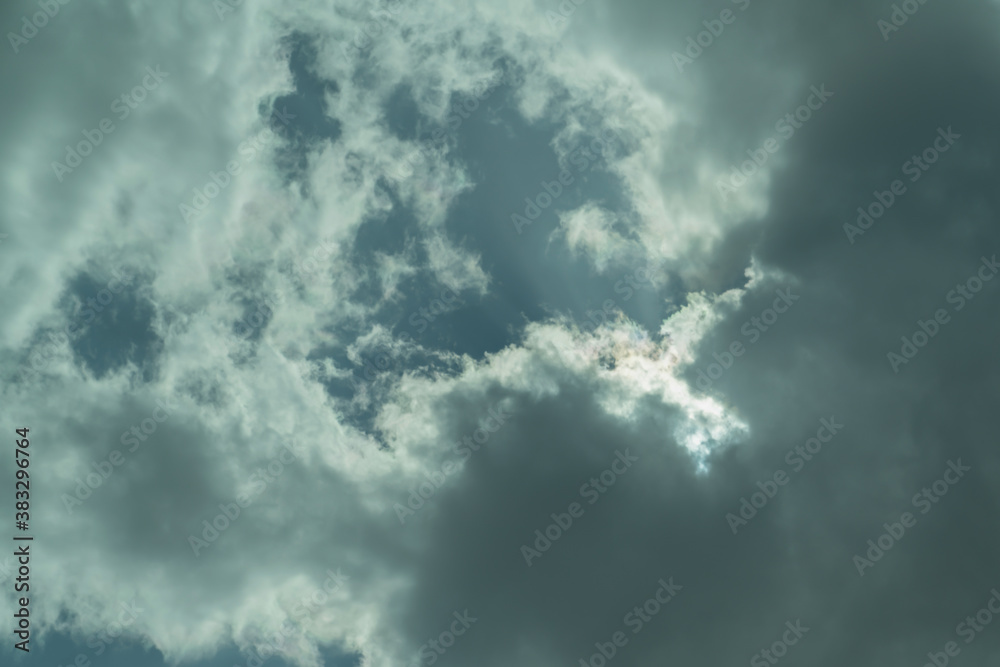 Fototapeta premium Front of storm clouds over blue sky. Big cloud with the blue sky. Rain cloudy. Sky after raining. Background of beautiful nature. A piece of blue sky among clouds..