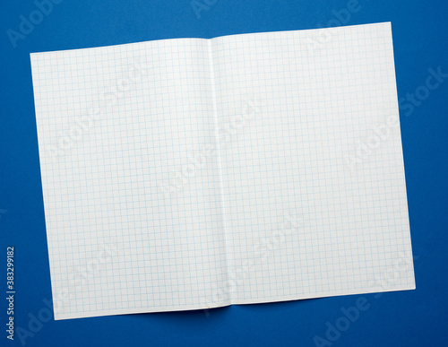 white sheet of paper in a cage from a school notebook on a blue background