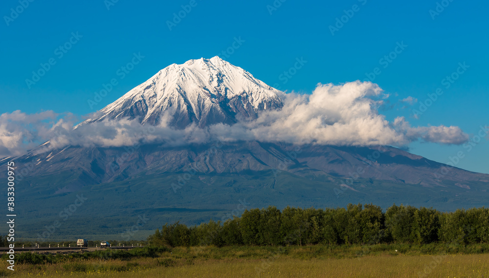 Panoramic view of a large volcano with a snowy peak
