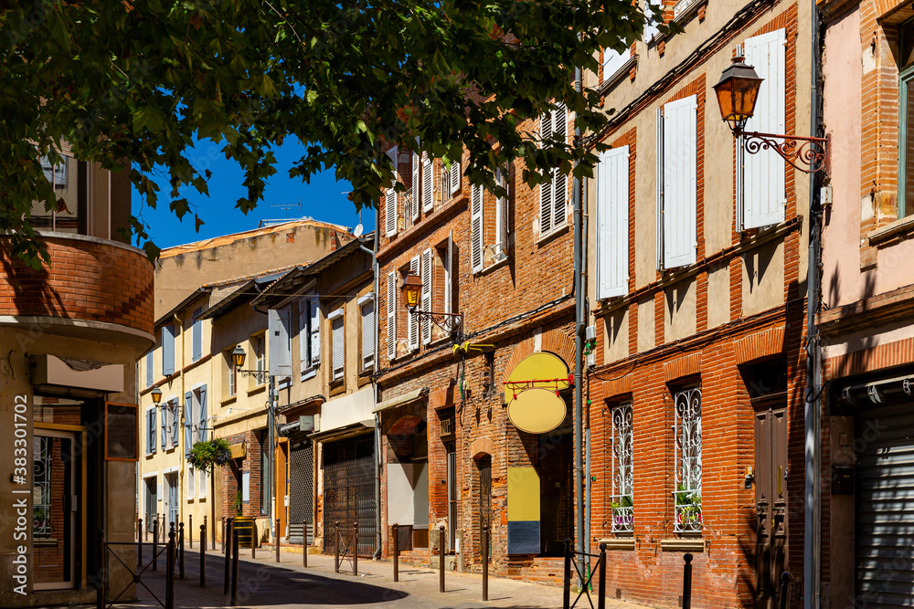 Picturesque view of old houses and streets of Muret town at sunny summer day, France