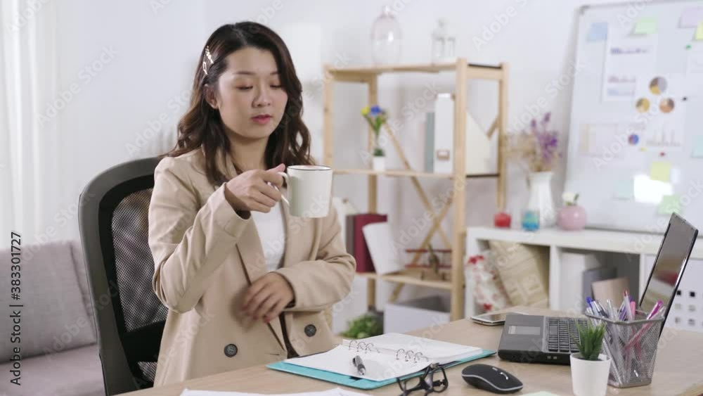 taking short break from work. beautiful secretary done managing agenda on notebook, sipping tea in chair and looking into distance with a smile. taking short break from work. beautiful secretary done managing agenda on notebook, sipping tea in chair and looking into distance with a smile.