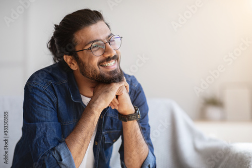 Portrait Of Smiling Indian Man With Eyeglasses And Braces In Home Interior photo