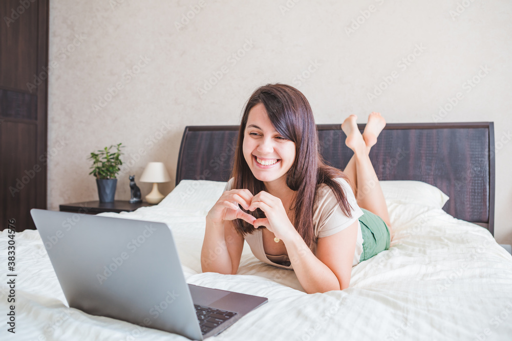 young pretty woman talking by video chat on laptop. online dating young pretty woman talking by video chat on laptop. online dating