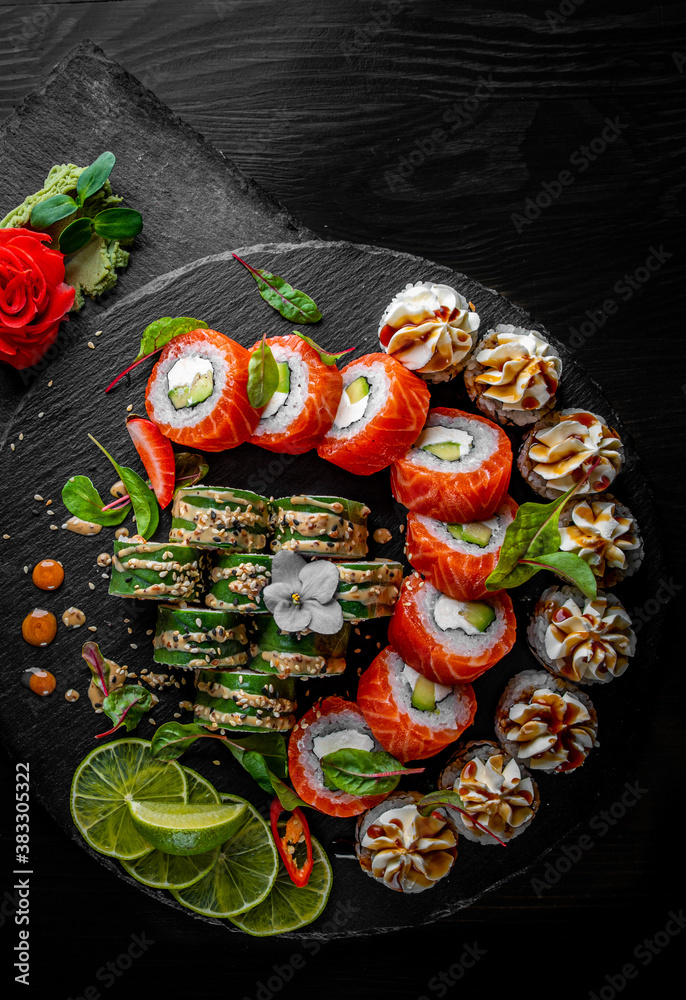 set of sushi roll with salmon, avocado, cream cheese, cucumber, rice, caviar, eel, tuna in plate