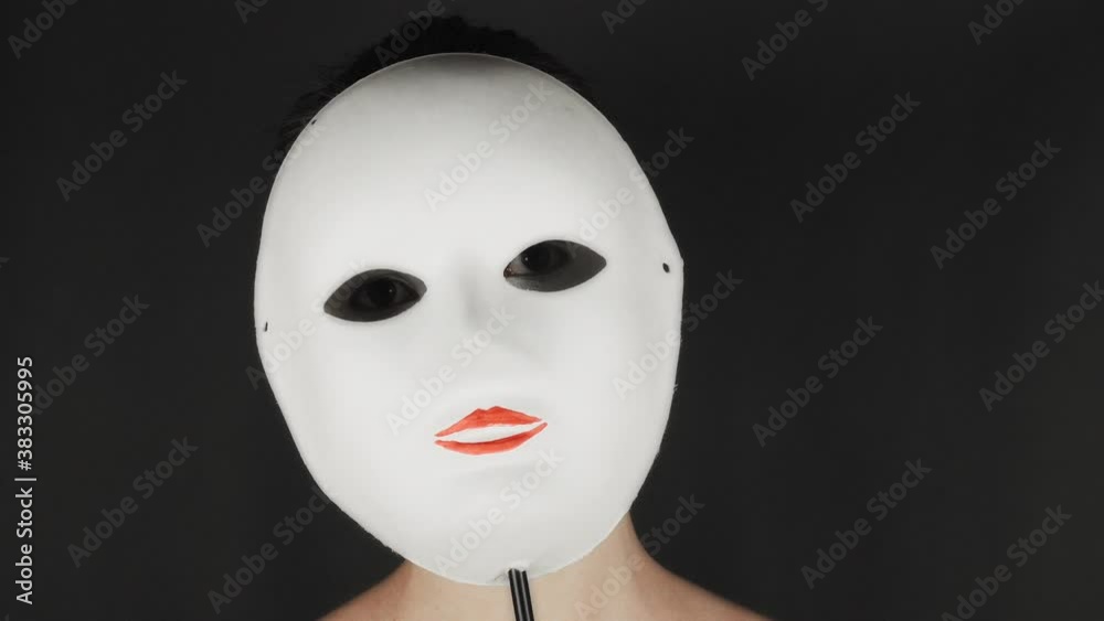 Portrait of a mime and bodypainting woman in white with black lips. Mime woman on black background. 