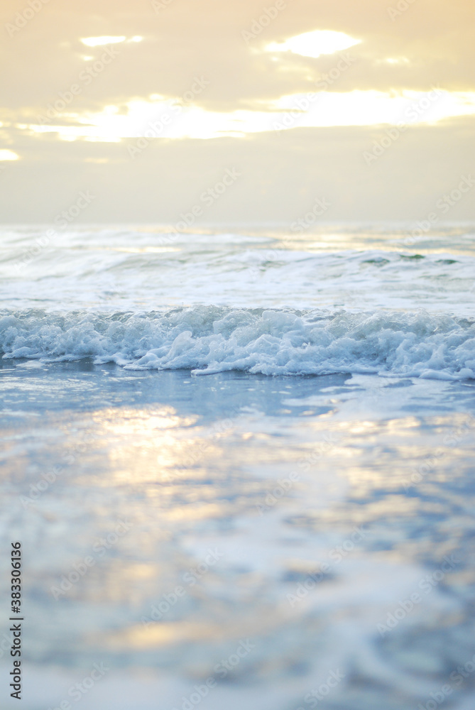 Ocean wave on a sandy beach in the morning