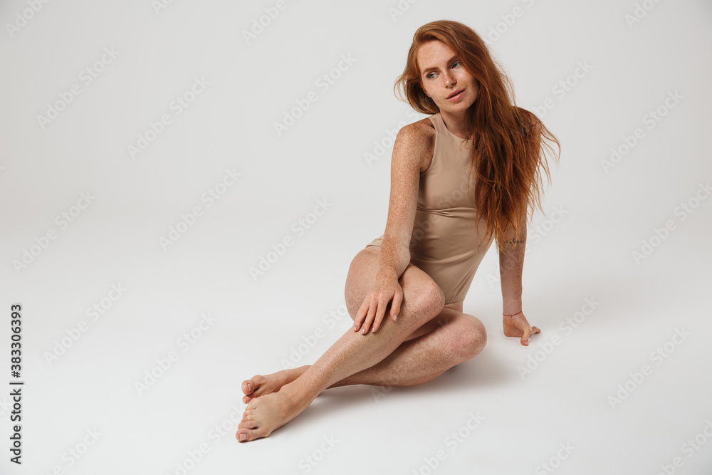 Fototapeta premium Redhead woman with freckles posing isolated