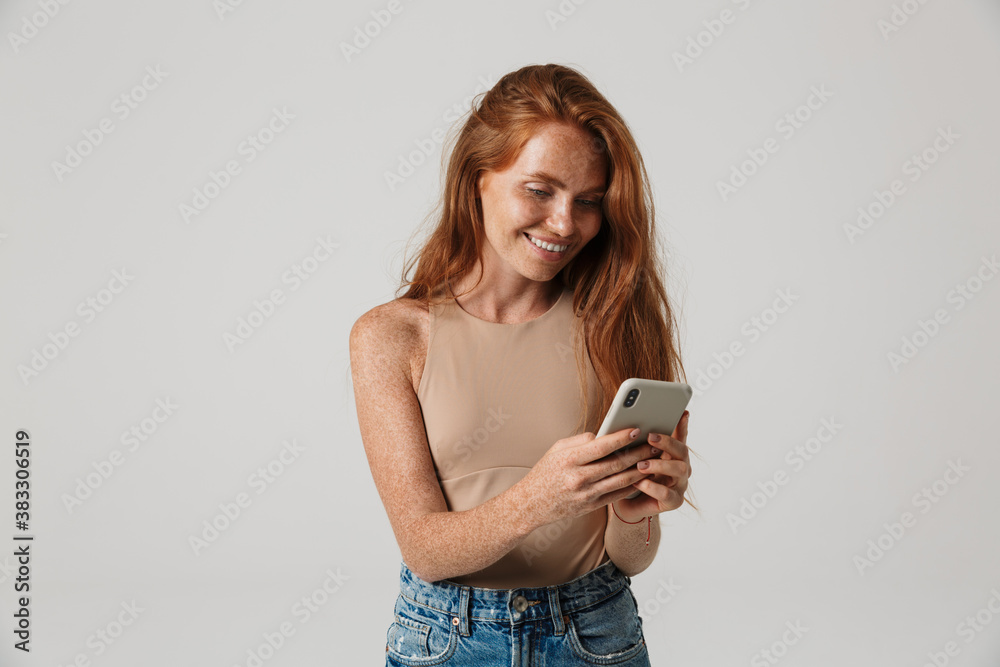 Cheery redhead woman with freckles using mobile phone Cheery redhead woman with freckles using mobile phone