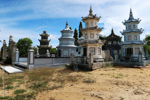 Hoi An, Vietnam, October 4, 2020: Pagodas with tombs at the Chua Van Duc Temple cemetery in Hoi An photo