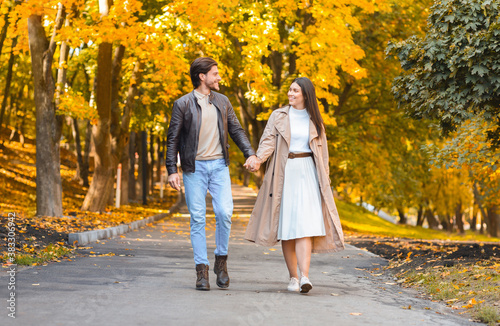 Beautiful picture of couple in love walking by autumn forest