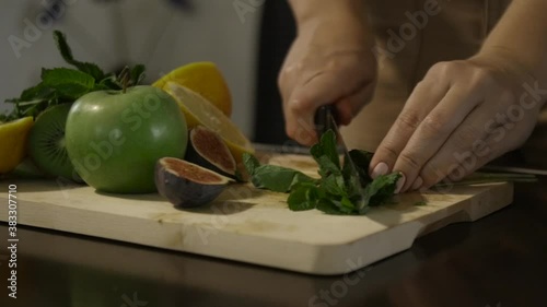 Woman slicing mint on the table