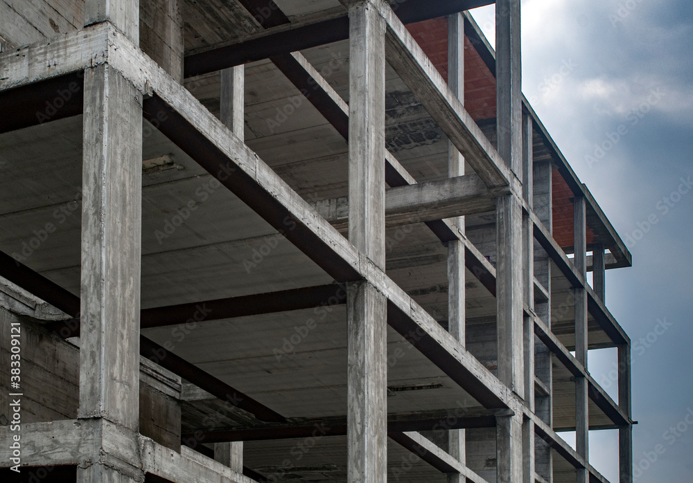 © angelo.gi - Reinforced concrete construction, load-bearing structure on cloudy sky background