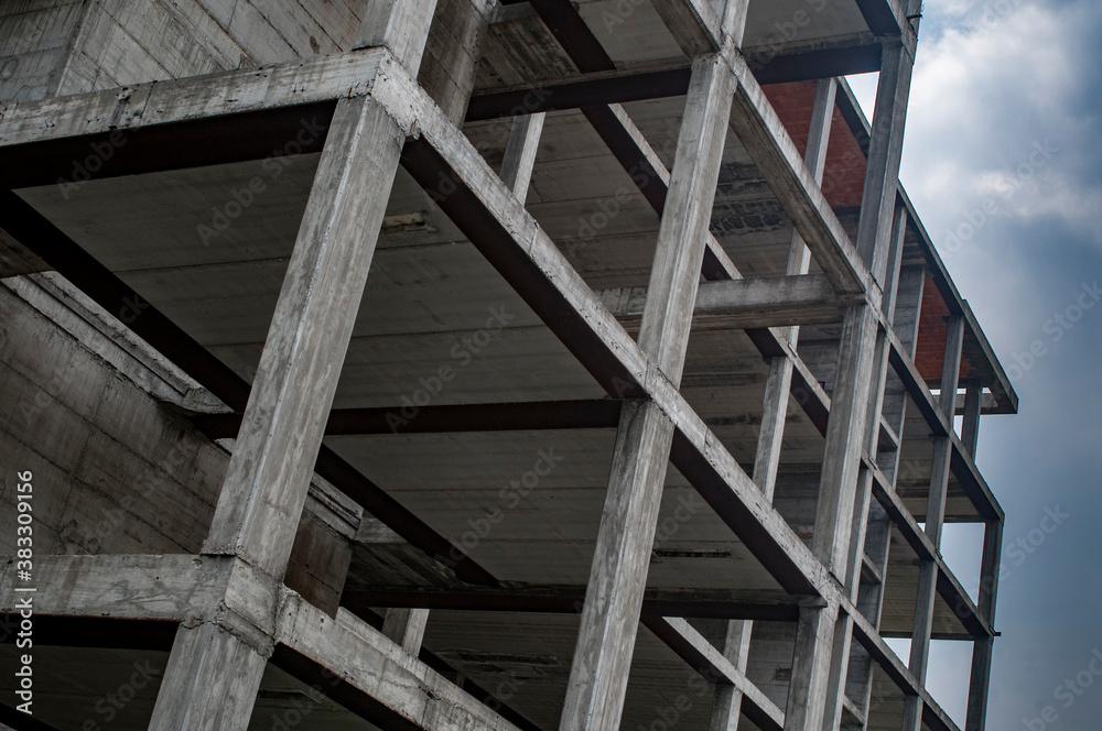 Reinforced concrete construction, load-bearing structure on cloudy sky background
Reinforced concrete construction, load-bearing structure on cloudy sky background