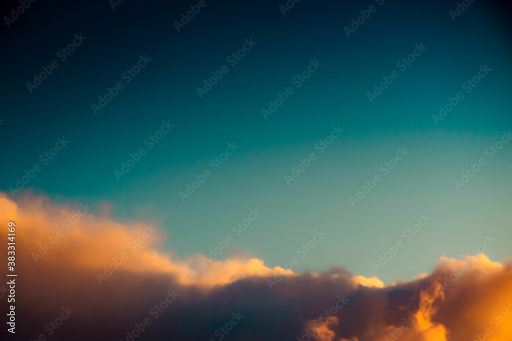 Top of a sunset cloud turns pink after sunset dramatic background