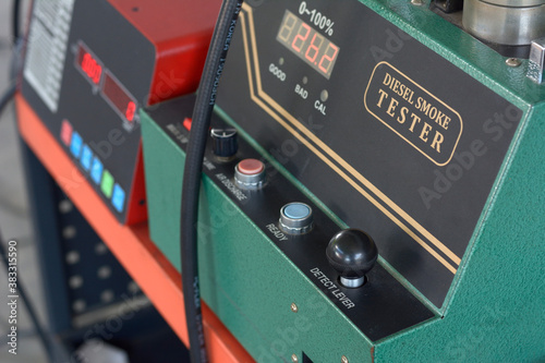 Digital diesel smoke tester at vehicle inspection station.