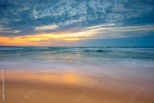Beach sunrise over the sea and dramatic sea © Gerisima