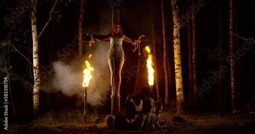 Manifestation of Satanism in the religious community. Crucifixion of a girl on the cross. People in a narcotic trance intoxicated Orgy under the crucifixion