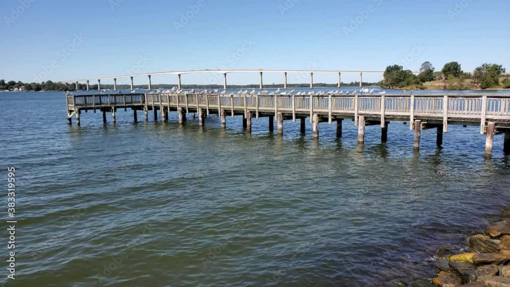 Gov. Thomas Johnson Bridge, Solomons Island, Calvert County, Md. The bridge crosses the Patuxent River right before it merges with the Chesapeake Bay. A pier lined with seagulls is shown n front. Gov. Thomas Johnson Bridge, Solomons Island, Calvert County, Md. The bridge crosses the Patuxent River right before it merges with the Chesapeake Bay. A pier lined with seagulls is shown n front.