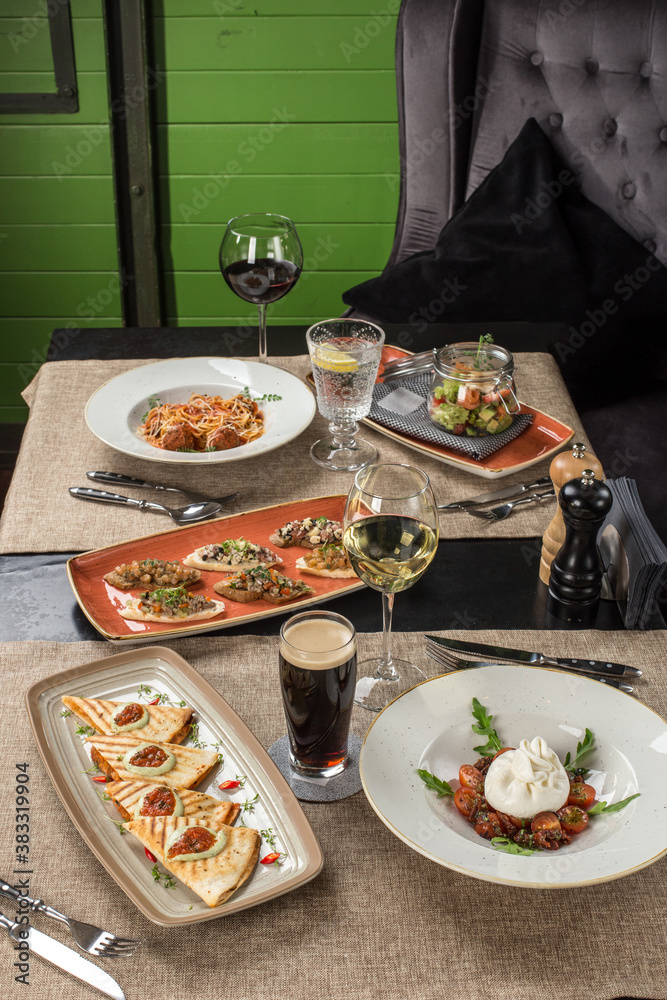 Gourmet meals assorted set appetizer tartare, barrata, pasta on the table Buffet at restaurant
