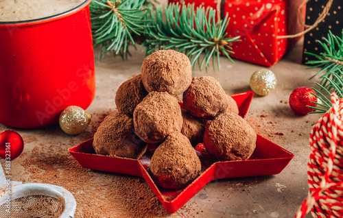 Homemade chocolate truffles candy ball on a christmas background. photo