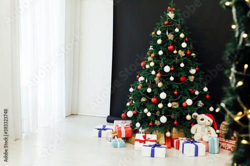 Christmas tree pine black interior room new year decor garland gifts postcard