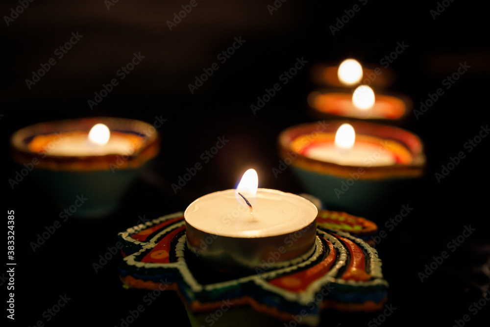 Happy Diwali day. Colorful traditional oil lamp diya on dark background. Happy Diwali day. Colorful traditional oil lamp diya on dark background.