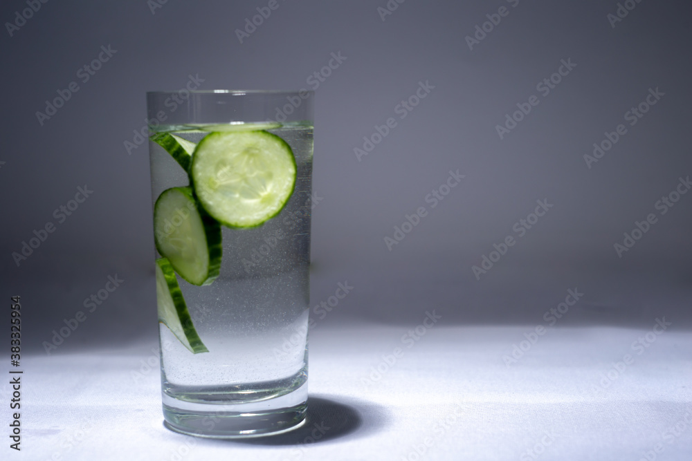 Glass cup with water and cucumber slices Glass cup with water and cucumber slices