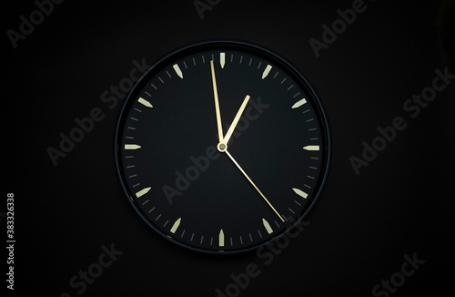 Minimal black clock Isolated on black background, Copy space for your text, Time concept.