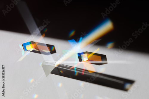 Photography Glass geometric figures prisms with light diffraction of spectrum colors and com