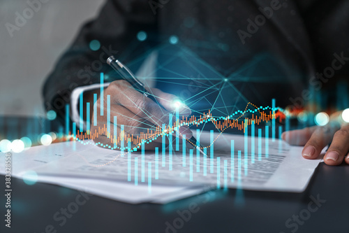 Woman signs agreement. Forex financil market chart and graph hologram. Double exposure . Brokerage concept. photo