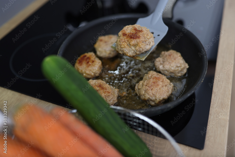 Chef uses spatula to flip over fried cutlets in kitchen closeup. Cooking meat dishes concept. Chef uses spatula to flip over fried cutlets in kitchen closeup. Cooking meat dishes concept.