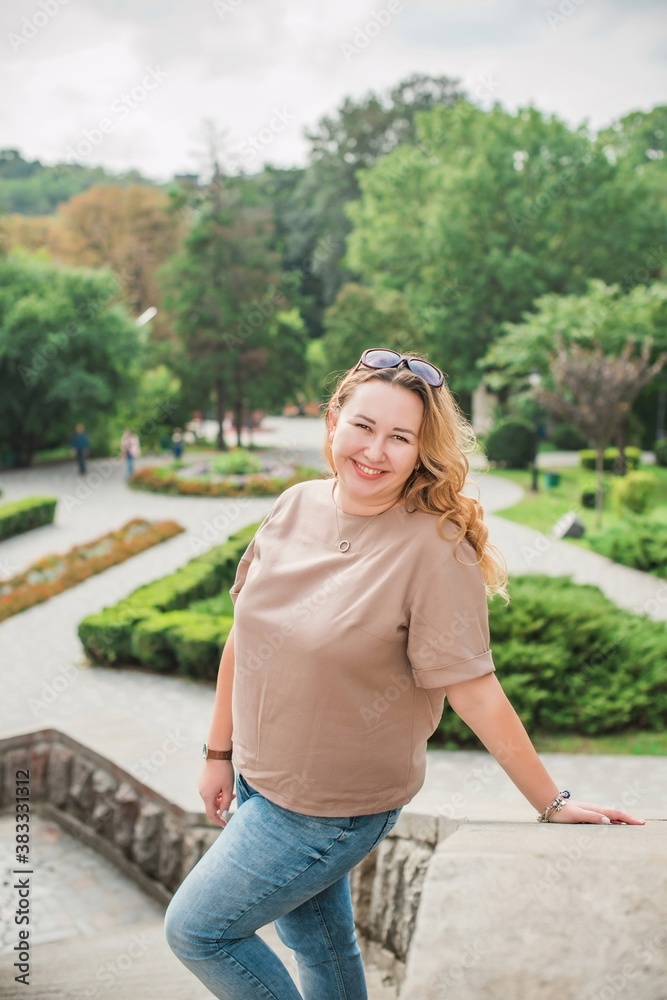 Obraz premium Happy smiling beautiful plus size model . Portrait large girl smiling on a sunny day with good mood, Photo of new age standard of beauty