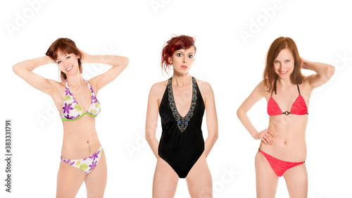 Portraits of three attractive young women wearing beachwear, isolated on white studio background