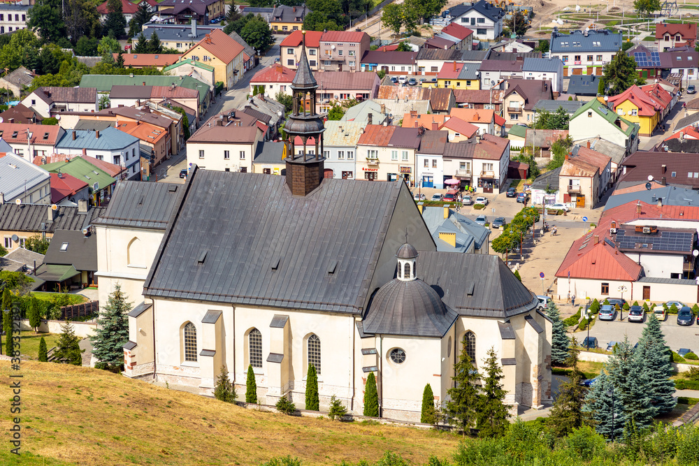 Panoramic view of town Checiny in Swietokrzyskie Mountains, with St. Bartholomew Church at slope of Royal Castle medieval fortress near Kielce in Poland Panoramic view of town Checiny in Swietokrzyskie Mountains, with St. Bartholomew Church at slope of Royal Castle medieval fortress near Kielce in Poland