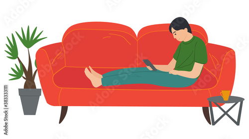 A man lying on the sofa, holding a smartphone. Relaxing at home concept vector flat design. Cheerful man is sitting on couch and is holding phone in hand. Rest time, leisure, free time after work