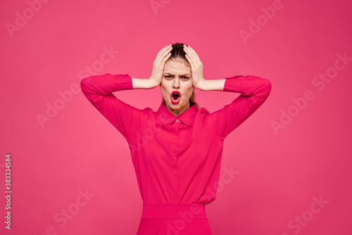 Woman on a pink background in fashionable clothes and bright makeup hairstyle model Copy Space © SHOTPRIME STUDIO