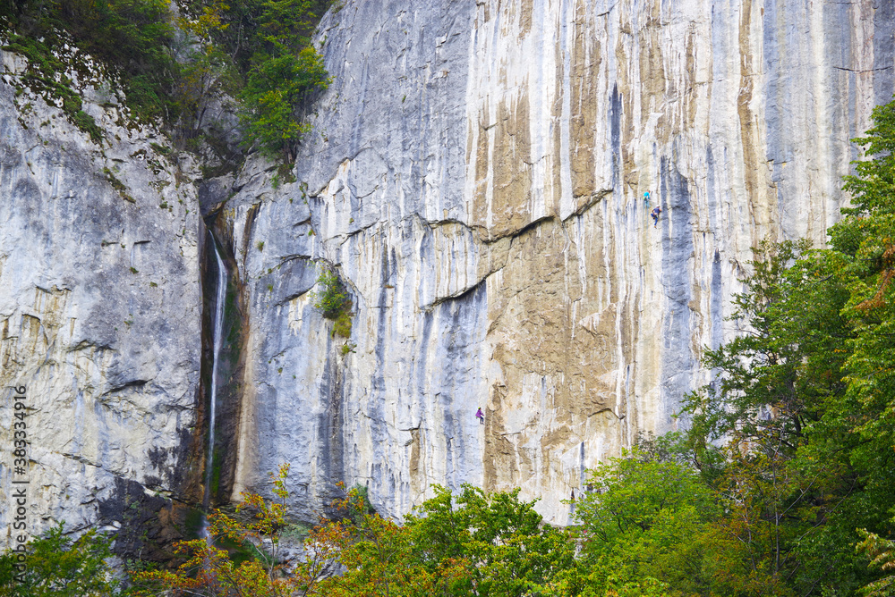 Summer in the mountains. Waterfall over a rock wall. Vanturatoarea Waterfall in Cernei Mountains Summer in the mountains. Waterfall over a rock wall. Vanturatoarea Waterfall in Cernei Mountains