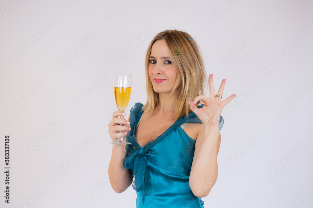 Young celebrating woman blue dress. Beautiful model portrait isolated over studio background hold wine glass. Young celebrating woman blue dress. Beautiful model portrait isolated over studio background hold wine glass.
