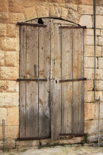 old wooden door in stone wall photo